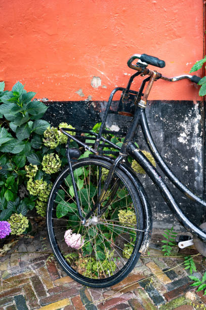 istock Old black bicycle stands against a house wall 2194882704