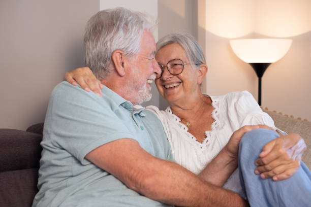 istock Happy cheerful bonding senior retired couple sitting on sofa having fun enjoying peaceful and relaxed moments together at home. 2194883111