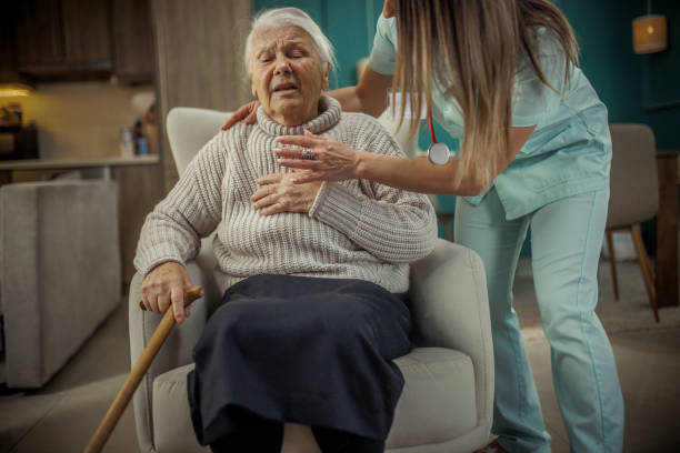 Caregiver supporting disabled woman in standing