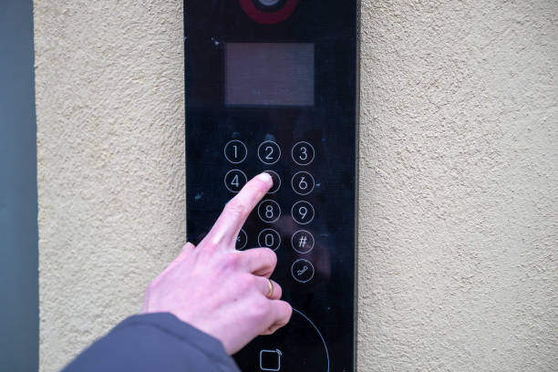 istock Close-up of a hand pressing a button on a digital intercom keypad, concept of security and access control 2194885330