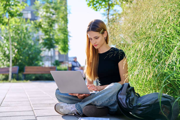 istock Young female college student typing on laptop computer outdoor 2194886728