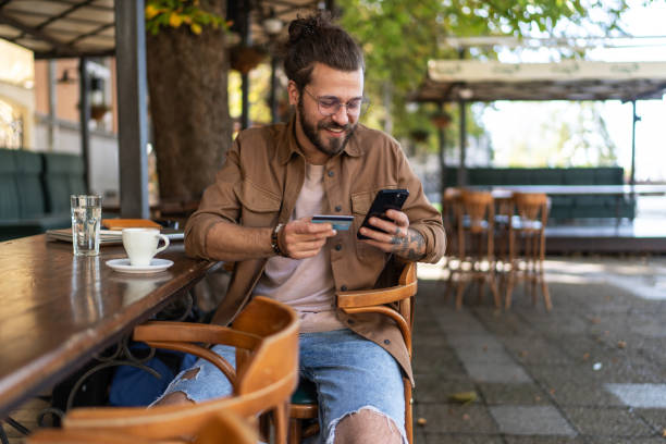 istock Young man enjoying his coffee break and shopping online 2194887422