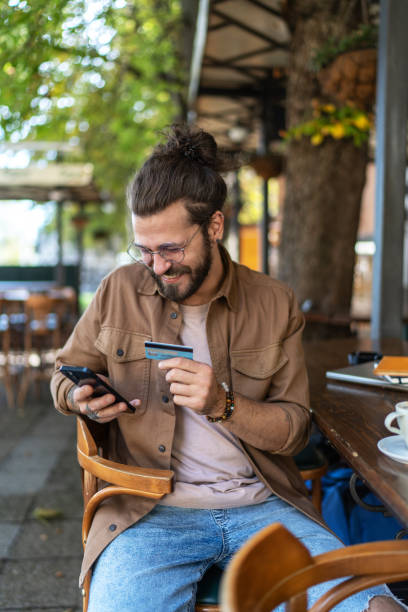 istock Young man enjoying his coffee break and shopping online 2194887737