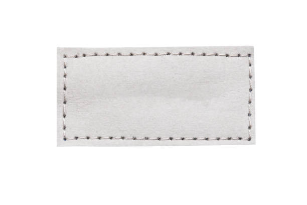 istock Gray leather belt strap closeup isolated on white. Grey stitched leather seam frame label tag isolated on white. 2194888254