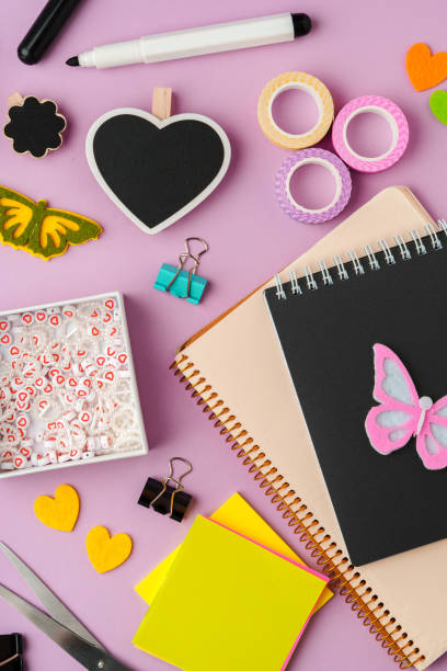 istock Crafting supplies for scrapbooking arranged on a purple surface 2194889976