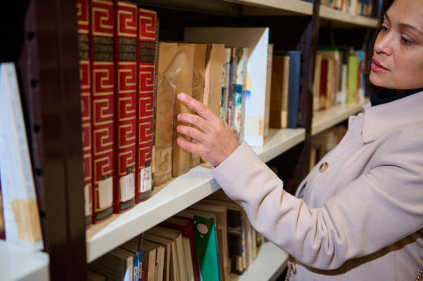 istock Woman browsing library bookshelves on National Library Day 2194890402
