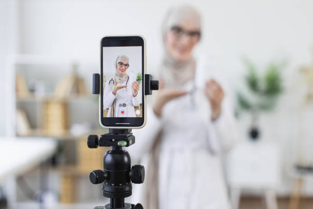 istock Muslim woman recording health tutorial with medicine bottles 2194891604