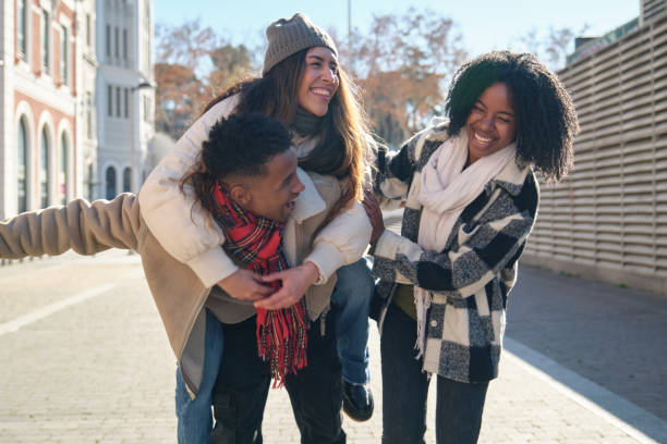 istock Multi-ethnic friends having fun piggybacking in the city 2194892539