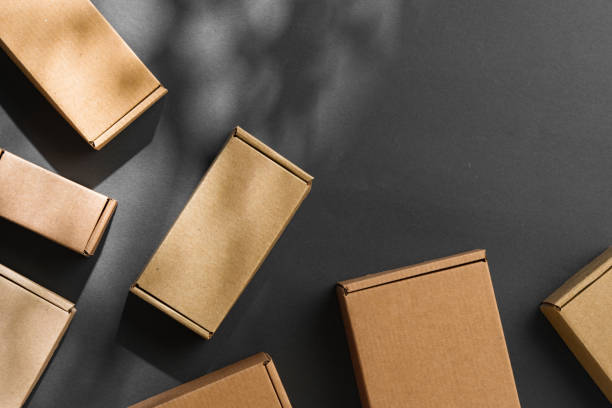 istock Various sizes of brown cardboard boxes arranged on a black surface with soft lighting effects during the day 2194892997