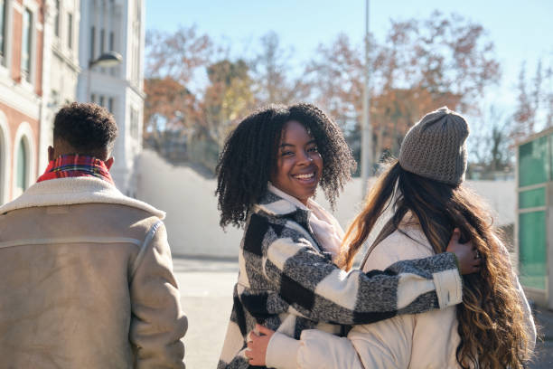 istock Young women hugging while walking in the city 2194894230