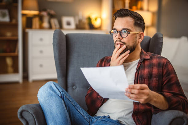 istock shocked and angry man sit and read document with a bad news 2194894557