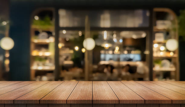 istock Empty wooden table top with lights bokeh on blur restaurant background. 2194894847