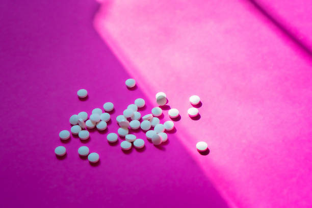 istock Assorted pharmaceutical medicine pills, tablets and capsules and bottle on pink background. Copy space for text 2194895074
