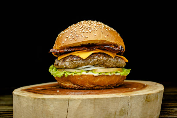 istock Delicious gourmet handmade burger with cheddar, special white sauce, crispy bacon, lettuce, tomato, onion and sesame seed bun. 2194895721