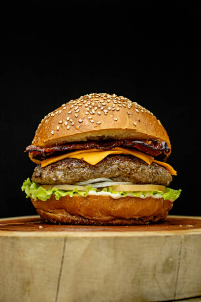 istock Delicious gourmet handmade burger with cheddar, special white sauce, crispy bacon, lettuce, tomato, onion and sesame seed bun. 2194895853