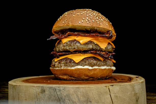 istock Delicious gourmet double handmade burger with double cheddar, special white sauce, crispy bacon and sesame seed bun. 2194895855
