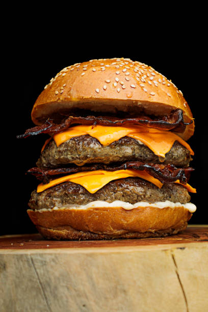 istock Delicious gourmet double handmade burger with double cheddar, special white sauce, crispy bacon and sesame seed bun. 2194895859