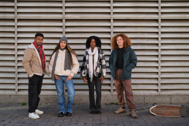 istock Four young friends posing in front of a wall 2194895999