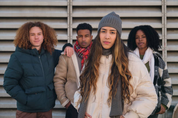 istock Four young adults posing in front of a metal wall 2194897925