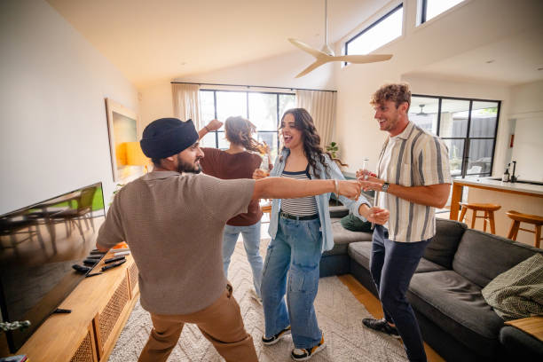 istock Cheerful friends dancing in bright inviting home space 2194900391
