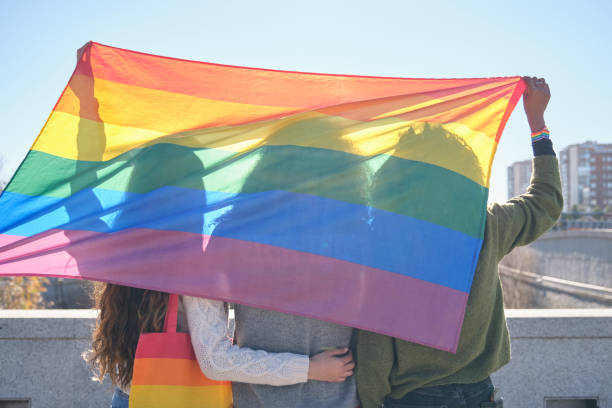 istock Activists holding rainbow flag celebrating gay pride 2194900713