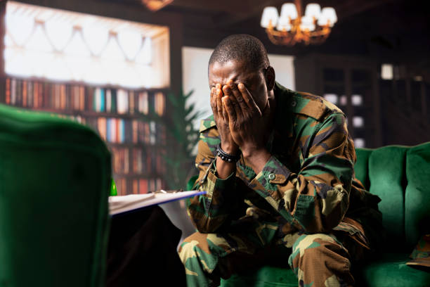 istock Black combat veteran faces grief and trauma crying at therapy session 2194900860