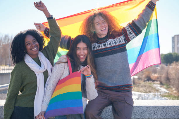 istock Young activists holding rainbow flag and celebrating gay pride 2194901158