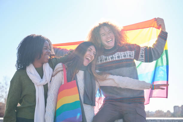 istock Young activists showing rainbow flag and laughing 2194901244