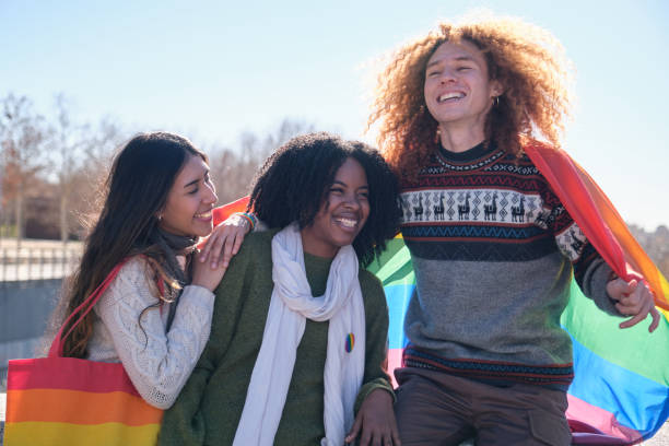 istock Young activists showing rainbow flag at a lgbtq+ event 2194902109