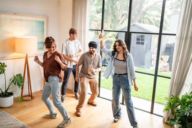 istock Four friends dancing in a light-filled modern room. 2194903906