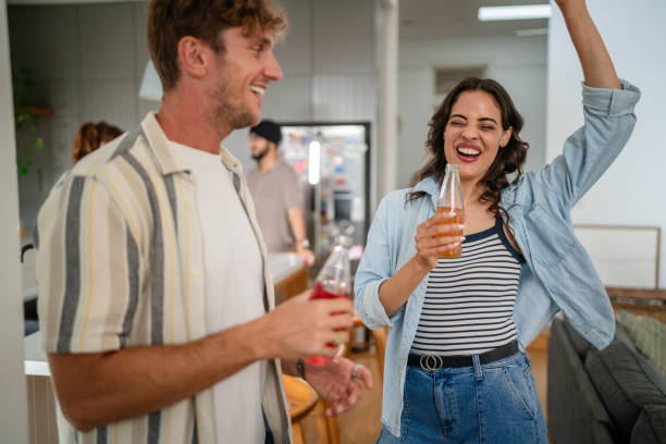 istock Friends enjoying festive drinks at a lively party 2194906343
