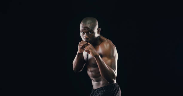 istock Black man, boxer workout and studio for challenge, fitness and battle courage on background. Male person, performance training and strong power with martial arts, portrait and athlete on mockup space 2194906541