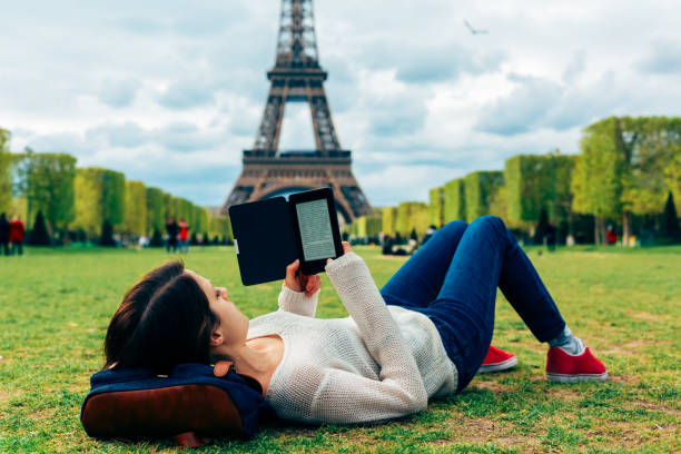istock Woman resting and reading an e-book near the Eiffel tower 2194907268