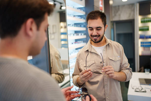 istock Customer man buying new sunglasses at the optic store. 2194909627