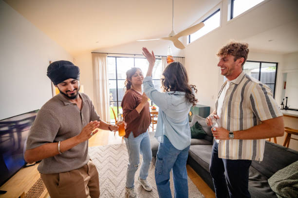 istock Happy friends dance lightheartedly in shared living room 2194910228