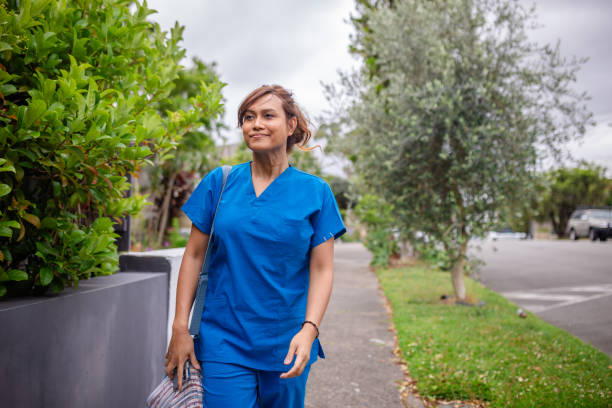 istock Health worker walking through green suburban area 2194911095