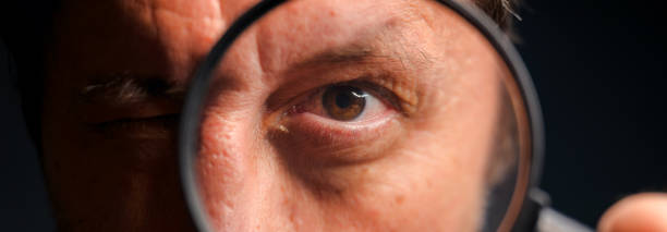 istock Private investigator detective with magnifying glass 2194911098