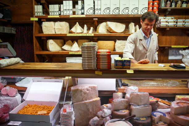 Bologna, Italy - 04/2018: Cheese Vendor in Bologna, Italy. Despite being a small shop, it offers a variety of Italian cheeses. It is especially famous for its aged Parmigiano Reggiano cheese.