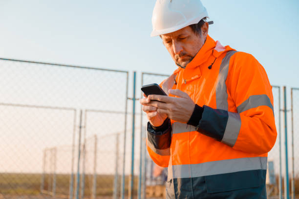 istock Drilling rig engineer using mobile phone while supervising the process of oil and gas, monitoring rig performance in field 2194911953
