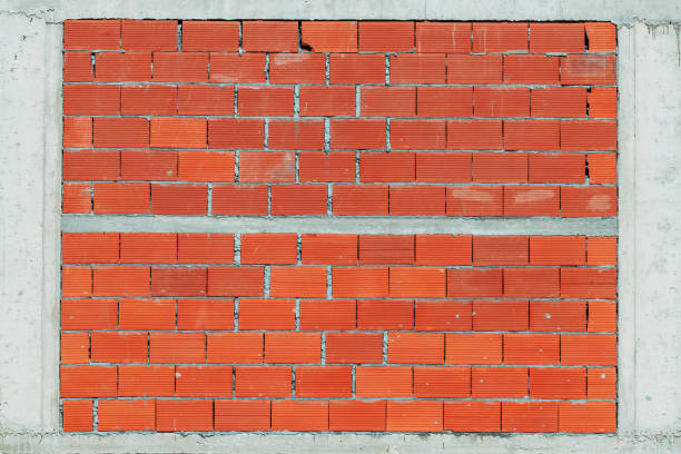 Building wall made of concrete frame and clay blocks as background