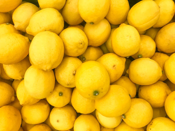 upper view on juicy lemon and yellow flowers decoration