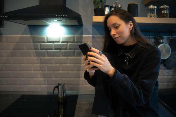 istock Young Woman at home using smartphone 2194917475
