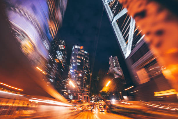 A vibrant city scene at nighttime with abstract motion blur, showcasing illuminated skyscrapers and glowing streetlights, creating a vivid and dynamic atmosphere.