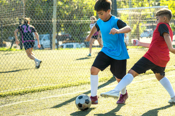 Children Playing a Soccer Game Outdoors With Focused Expressions