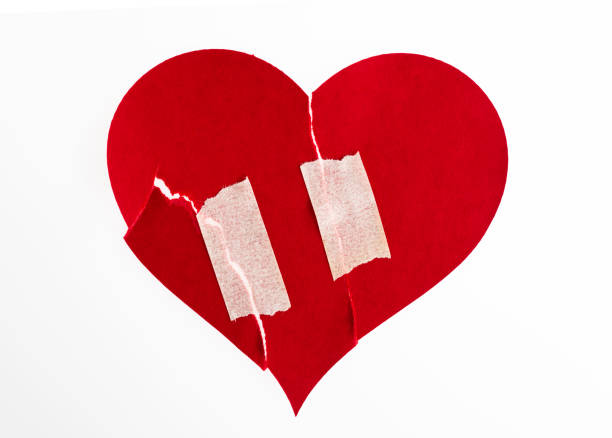 istock Broken heart with adhesive tape on white background 2194919136
