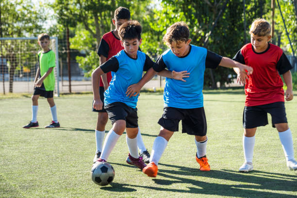istock Kids Engaging in a Soccer Match on a Sunny Field 2194919302