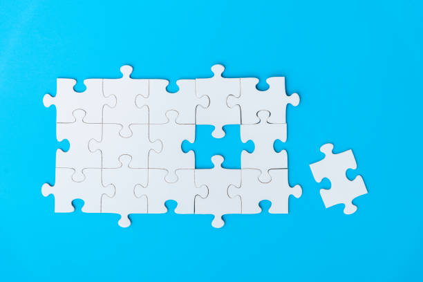 istock Top view of white puzzle pieces on blue background 2194919793
