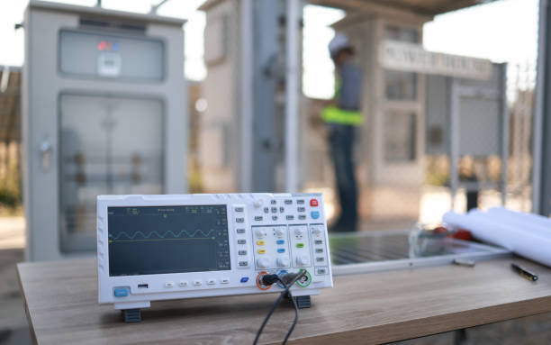 A white electronic device with a black cord attached to it. The device is a multimeter and is displaying a graph