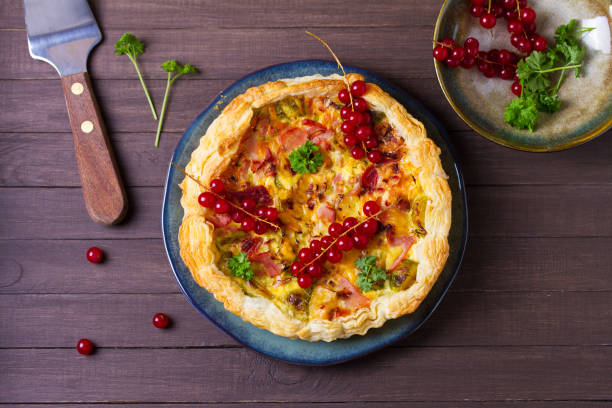 istock Quiche with chunks of ham, creamy brie and vegetables 2194922133