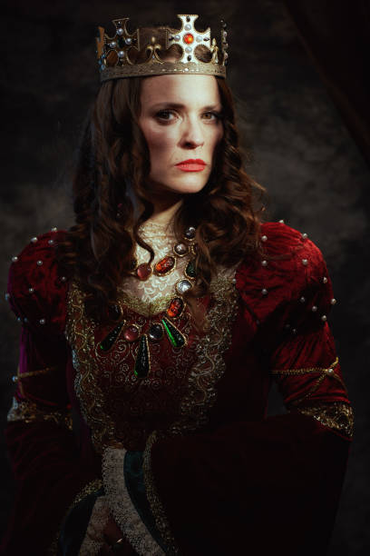 istock medieval queen in red dress with crown 2194922270